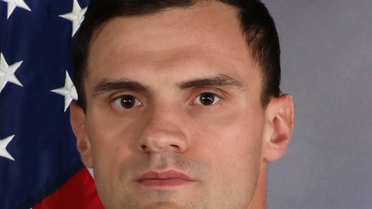 Laurel graduate carries flag during Husker 9/11 tribute