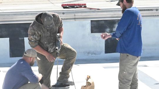 Workers dive into swimming pool repairs