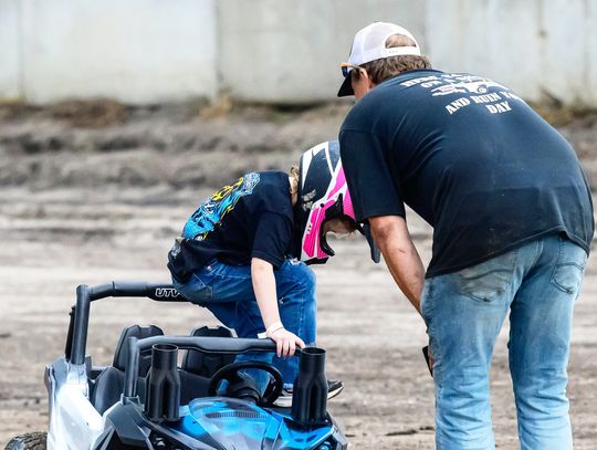 A power wheels demo derby driver climbs out of her vehicle after the wheels broke on her ride during Friday night’s competition at the Dixon County Fair
