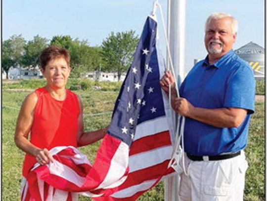 Gail and Dennis Bazata send up the flag