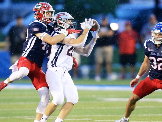 (top) Cedar Catholic’s Grant Arens goes up for a pass break up during action in Saturday’s Shrine Bowl football game in Kearney