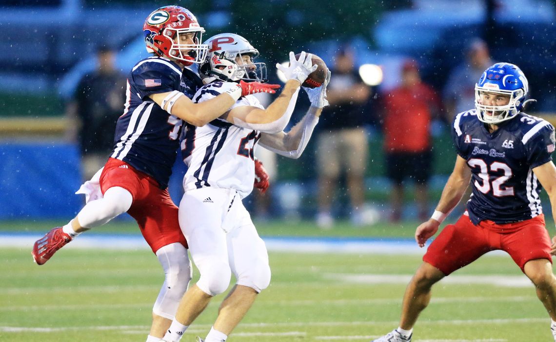 (top) Cedar Catholic’s Grant Arens goes up for a pass break up during action in Saturday’s Shrine Bowl football game in Kearney