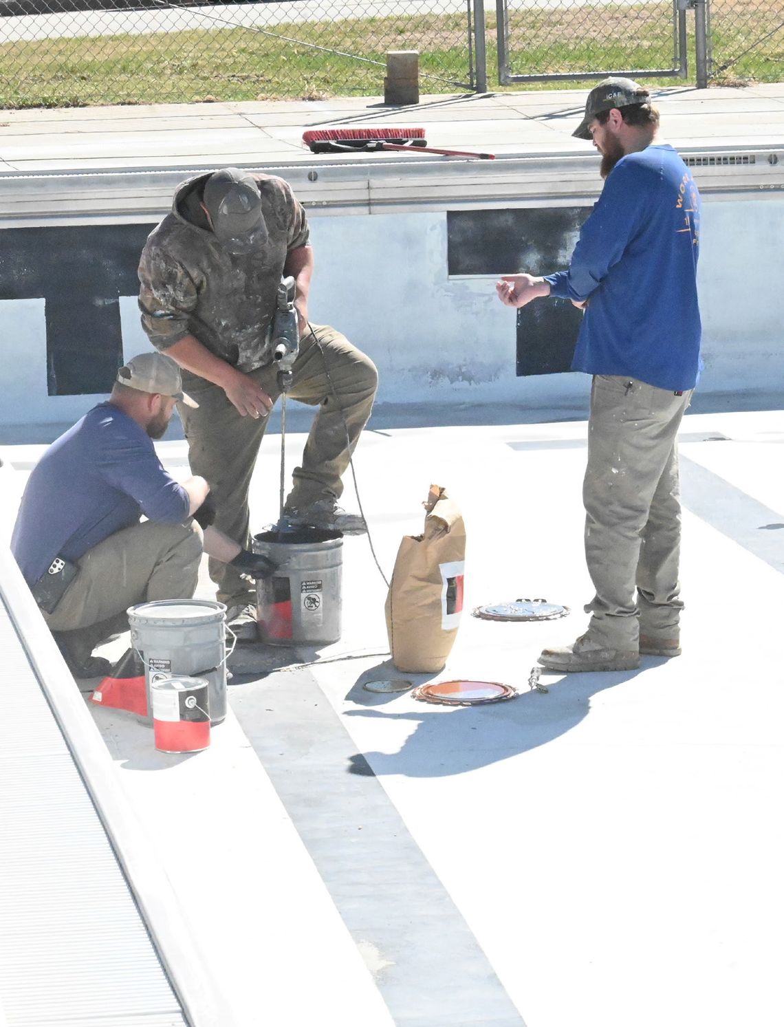 Workers dive into swimming pool repairs