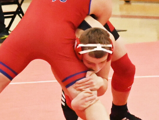 Cedar Catholic’s Maverick Heine gets started on pushing his Clarkson-Leigh foe to his back during action here last Tuesday. Heine ended up winning the match with a pin. (right) Castin Pinkelman shoots in for the takedown during his match on Tuesday. Kel