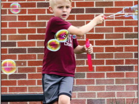 Finn McKamy takes a moment to play with his bubble blower as he exits school for summer break on Friday afternoon. Sandra Cross | Laurel Advocate