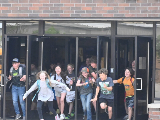 Hartington-Newcastle Elementary School students burst through the doors last Thursday as the final bell of the day rings, signalling the end of school for the summer. Rob Dump | Cedar County News