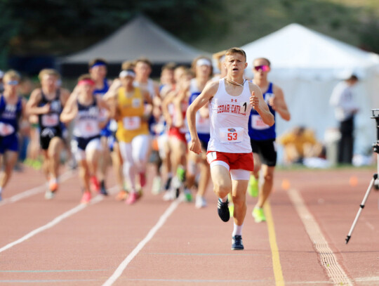 Cedar Catholic’s Carson Noecker leads the pack around the Burke Stadium track enroute to a new state record. He has won the 3,200 meter race all three times he has competed in it at State.