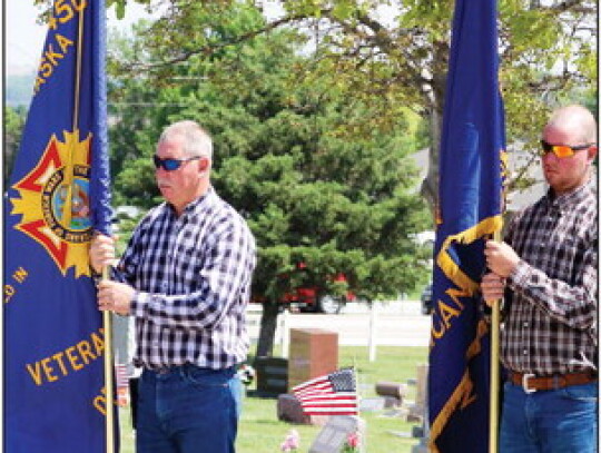 Steve Luedtke, with his son Jacob Luedtke, stand with the flags during the cemetery ceremony. They are the son and grandson of Vietnam veteran Lloyd Luedtke, who recently died. Sandra Cross | Laurel Advocate