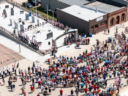 Around 400 people from all walks of life, young and old, gathered Saturday at the intersection of Broadway St. and State Ave., in 80 degree temperatures to witness the dedication of Hartington’s Veterans Memorial. Photo Courtesy of Anderson Aerial/Josh 