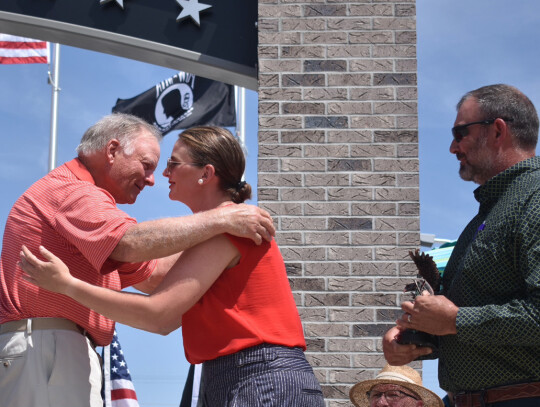 Dan Kathol thanks Drs. Erin and Ben Schroeder for the donation of the lot, and now home, of the Hartington Veterans Memorial.