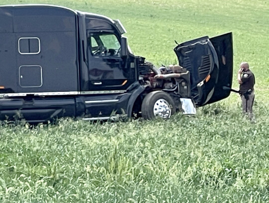 Cedar County Sheriff Larry Koranda surveys the damage to a semi truck that ended up in a field Wednesday afternoon after a collision. Two semi-trucks collided at the intersection of U.S. Highway 81 and Highway 84. No injuries were reported, however. Rob D