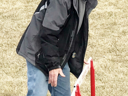 Superintendent Jeff Hoesing lines up hurdles at a Junior High track meet this spring. Described as a “servant leader,” Hoesing is known for pitching in and helping no matter the task. Trisha Benton|Randolph Times