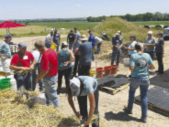 Bow Creek Field Day participants prepare buckets to build a compost bin.