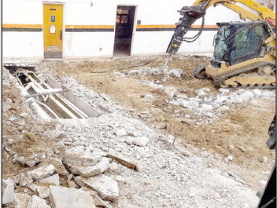 Demolition work proceeds on part of the elementary school hallway and kitchen area. Lots of history was hidden underneath those bricks and the floor. Photo courtesy of Drew Detlefsen