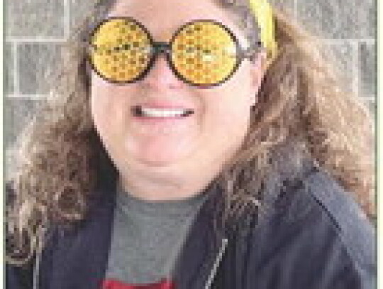 Christina Junck dresses up in antennae and honeycomb glasses Saturday during the Randolph Community Fair. At left, the Scott Junck family: Owen, Chase, Jill, Tommy, Scott, Emmett, Andrew and Charlie, won first place for best group costume at the Buzzin’