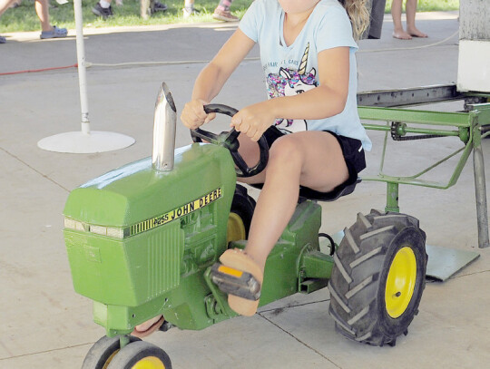 Lila Miller, Randolph (above left) keeps her head down and feet pedaling and Makenna O’Connor, Norfolk, (above right) competes in the Kiddie Tractor Pull during the Randolph Community Fair Sunday. Jeri Schmit and Darin Epperly|Randolph Times