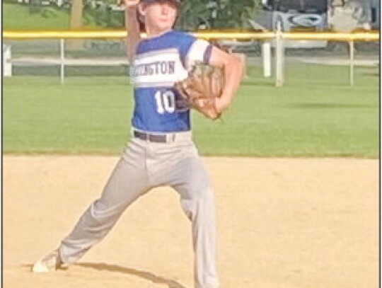 Hartington’s Hunter Bensen fires a fastball toward home plate during action in Monday night’s Quad County League game at Neligh. Bensen earned the win on the mound in the contest and also hit a pair of home runs.