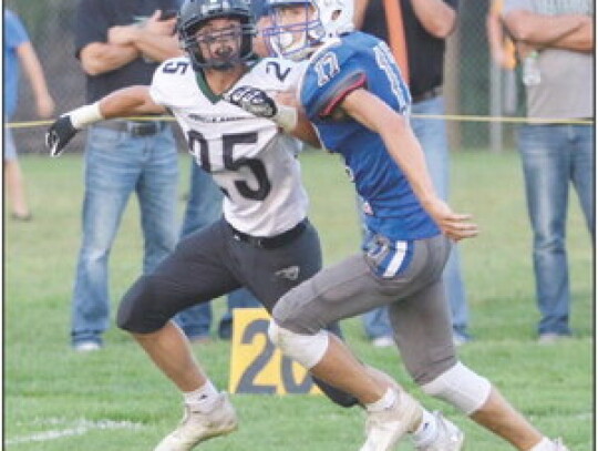 Wynot’s Dylan Heine makes sure Howells-Dodge’s Dylan Brichacek can’t slip past him on his route during action in Friday’s game at Wynot. The Blue Devils earned the 32-20 win to knock the Jaguars from the top spot in the Class D2 rankings. Courtesy