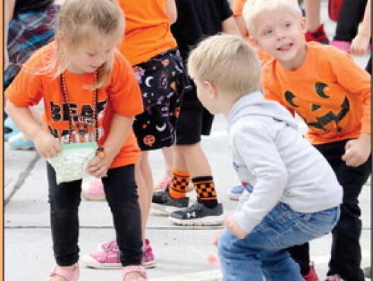 Back row: Molly Rager and Benjamin Lawyer, back to camera is Carl Weber picking up candy from the parade.