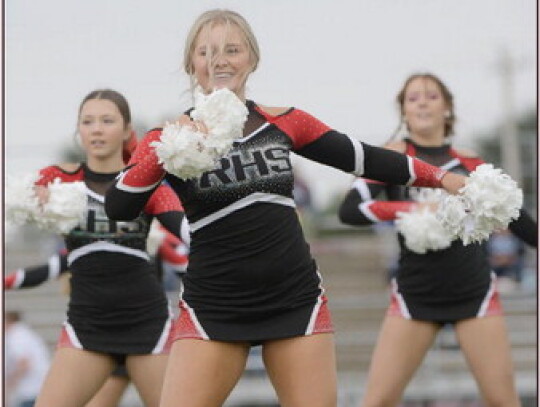 Ella Scott is out in front cheering for the Randolph Cardinals during Friday’s Homecoming football game. Lilly Kuchta and Katarina Greiner can be seen in the back. In the photo at left, Zoey Gubbels and her mother, third-grade teacher Kelsey Gubbels, ge