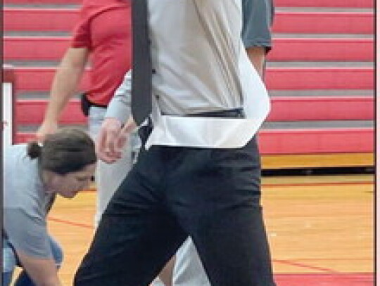 Brayden Shearer walks blindfolded during a senior skit at Friday’s pep rally. In the photo at left, PE teacher Eric Brown is pictured with clown Issac Reifenrath, the PE student teacher, for Rhyme Without a Reason Day. Jackie Loberg | Randolph Times