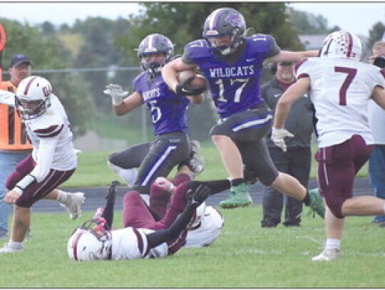 The Wildcats’ Jason Heimes (top) keeps a Wakefield runner from scoring as he makes the open-field tackle during first-half action in Friday night’s Homecoming game. Dayton Sudbeck (left) shows his defensive skills as he breaks up a pass attempt to the