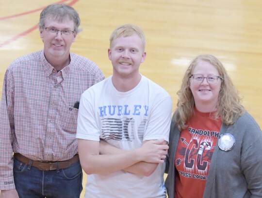 Senior Jake Harder (middle) is recognized along with his parents, Tyler and Stephanie Harder, for Cross Country Parents Night last week. Jeri Schmit | Randolph Times