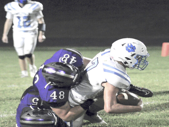 The Hartington-Newcastle Wildcats cranked their offense into high gear and picked up their second straight win of the season Friday night, handing Tri County Northeast a 48-8 setback. (right) Carter Kelly (20) and Tyler Hutchinson tackle Blake Kneifl of T