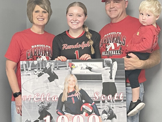 Jeri Schmit|Randolph Times Ella Scott gets down to the floor to dig a ball in subdistrict action Monday night against Santee. During the match, Scott racked up her 1,000th career dig. (Above right) Scott (center) is pictured with her parents Stacey and Ji