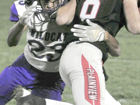 Brayden Lammers (23) of Hartington-Newcastle wraps up Gage Walton (8) of Plainview during playoff football atction Friday night in Plainview. Darin Epperly | Cedar County News