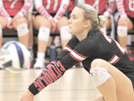 CedarCatholic’sAddison Walter and Lexi Eickoff go up for a block during action in Tuesday night’s SubDistrict title game in Crofton. (right) Katy Jones passes the ball to a teammate in third-set action at Crofton. The Lady Trojans dropped a five-set t