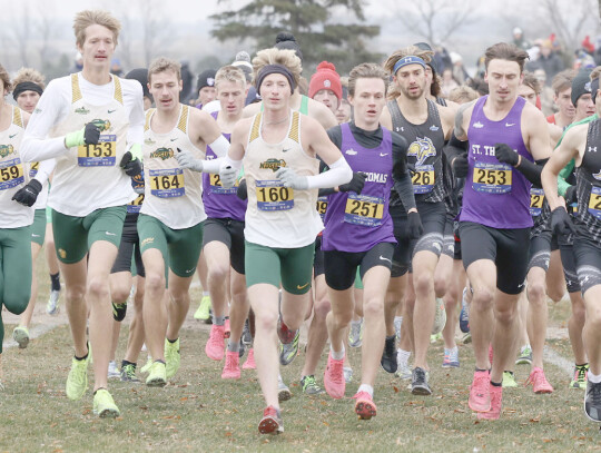 Cedar Catholic graduate Carson Noecker breaks away from the pack during the Summit League cross country meet at Brookings, S.D. Noecker then went on to out-distance the field in the eight-meter race to claim the conference title. His efforts helped his So