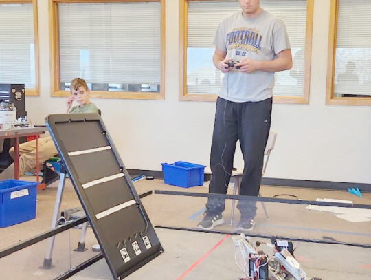 Senior Paul Kleinschmit operates a robot during Cedar Catholic High School’s robotics class. The Cedar Bots have competed in two meets so far during the 2023-24 season. Mark Mahoney | Cedar County News