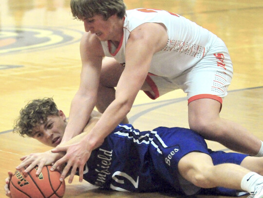 Laurel-Concord-Coleridge’s Tyler Olson and Jacob Smith of Bloomfield try and gain control of a loose ball during Lewis and Clark basketball action last Tuesday night in Laurel. Darin Epperly | Laurel Advocate