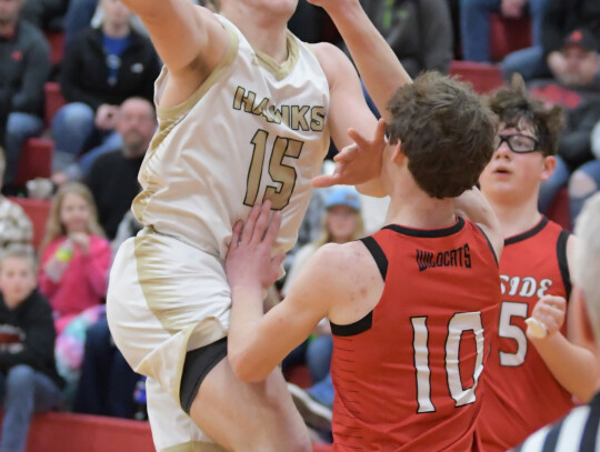 Xander Brown goes up and over top of Winside Wildcat defenders in the holiday tournament opening game. Jeri Schmit|Randolph Times