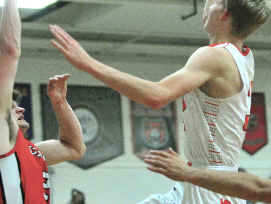 The Bears Carter Kvols drives in for a layup as Cedar Catholic’s Alex Kuehn tries to defend him during action in their non-conference game here last week. Darin Epperly | Laurel Advocate