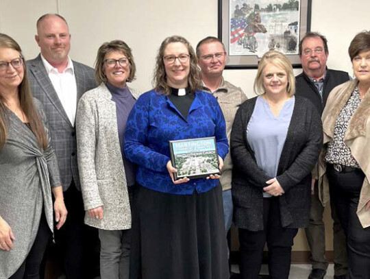 Hartington Chamber of Commerce President Karen Flamig and Vice President Ray Sukovaty present Laura Noecker, Pastor Amanda Talley, Jeff Jones, Heather Jones, Dan Steiner and Brenda Steiner with a plaque honoring Trinity Lutheran Church’s 150th anniversa