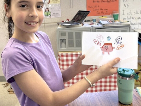 Eden Hansen shows off the drawing she made as part of the Purple Ribbon Kids program at Laurel-Concord-Coleridge School.