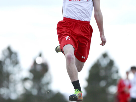 Matthew Schultz gets some air between him and the sand during triple jump competition this track season. Jeremy Buss|Randolph Times