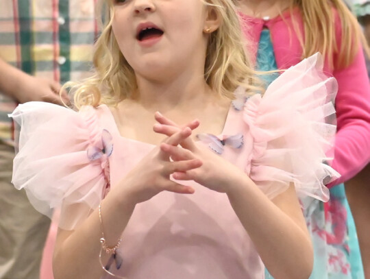 Holy Trinity students held their Spring Melodies Concert April 30 in the Msgr. Werner Activity Center. Preschooler Aurora Nissen (above, left) helped her classmates perform 'Take Take Me Out to the Ball Game.' Above, Kindergartener Jordy Feilmeier helps c