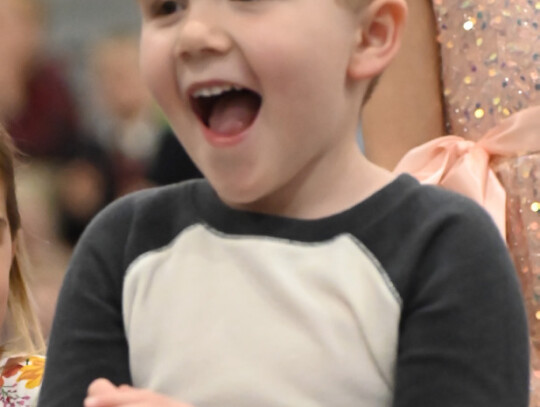 Holy Trinity preschooler John Beckman shows he knows his lines, as he helps belt out 'Take Me Out to the Ball Park.'