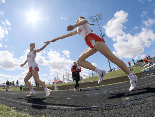 The Cedar Catholic relay teams have been working all season to shave time off their scores in preparation for this week’s District meet at the Hartington Community Complex. (above) Kally Becker and Claire Rolfes make the exchange during a recent race at