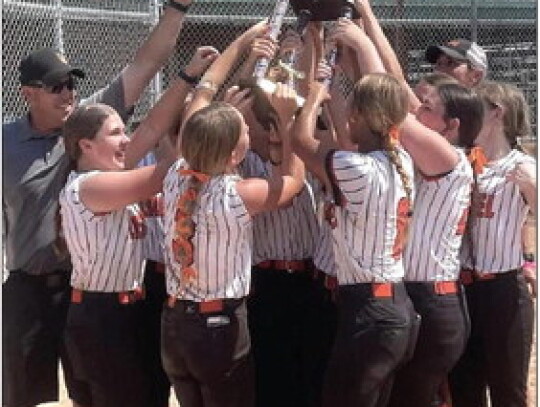 Laurel’s 14-and-under softball team celebrates with the trophy after winning the Class D state title Sunday in Hastings. The team had to work its way through the loser’s bracket to claim the title.